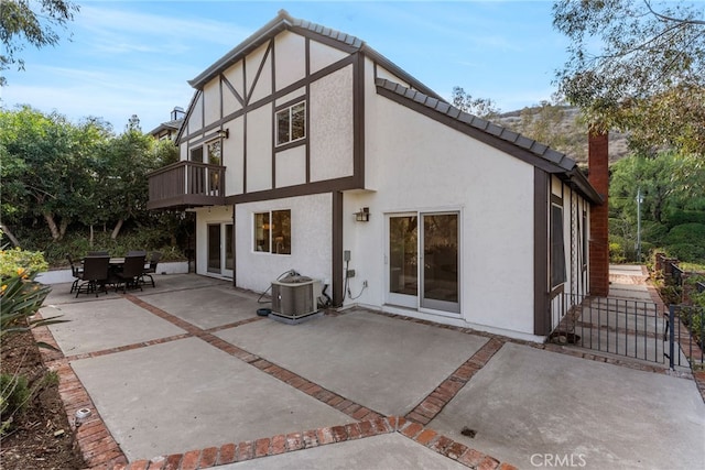 back of house featuring a patio area, a balcony, and central air condition unit