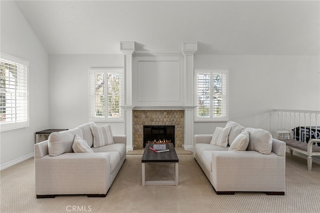 living room featuring lofted ceiling, plenty of natural light, and light carpet