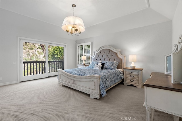 carpeted bedroom featuring access to exterior and a chandelier