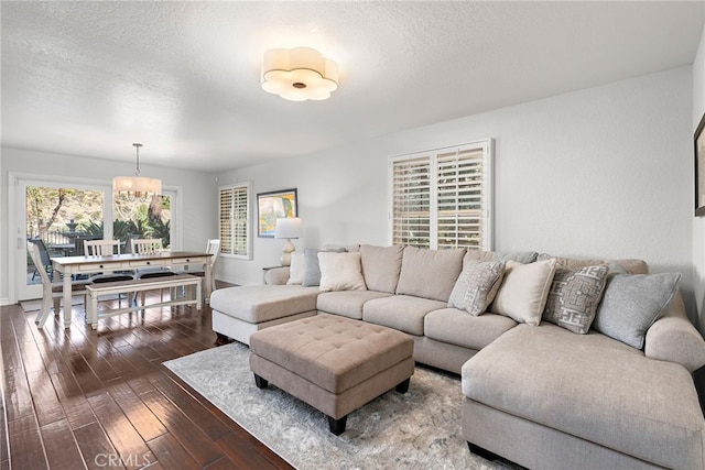 living room featuring dark hardwood / wood-style flooring and a textured ceiling