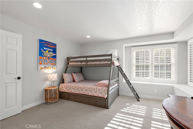 carpeted bedroom featuring a textured ceiling