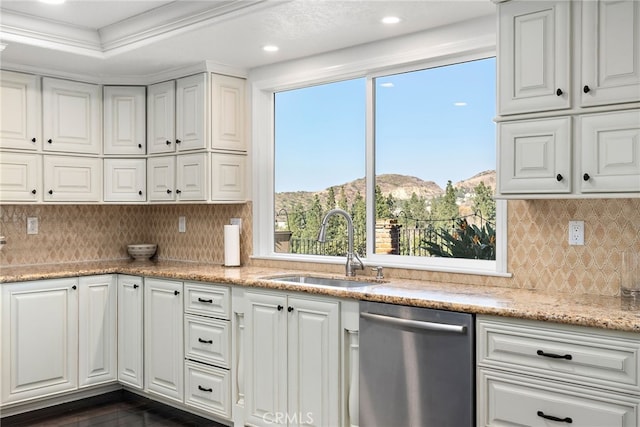 kitchen with sink, white cabinetry, light stone counters, dishwasher, and a mountain view