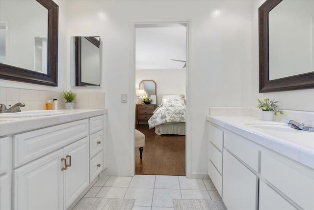 bathroom with vanity, tile patterned flooring, and decorative backsplash