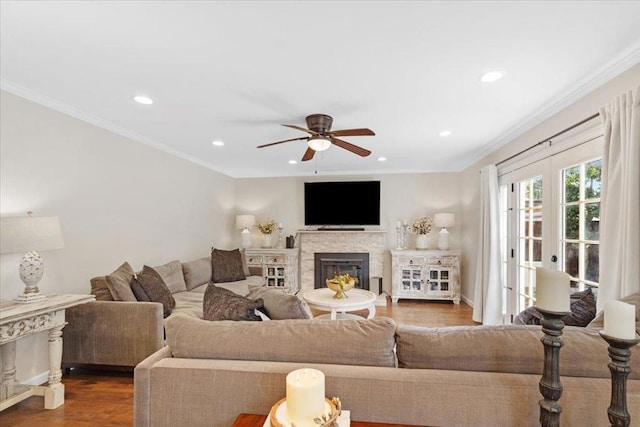 living room featuring ornamental molding, hardwood / wood-style floors, ceiling fan, and french doors