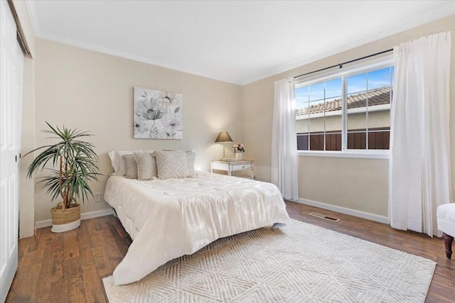 bedroom featuring crown molding and hardwood / wood-style floors