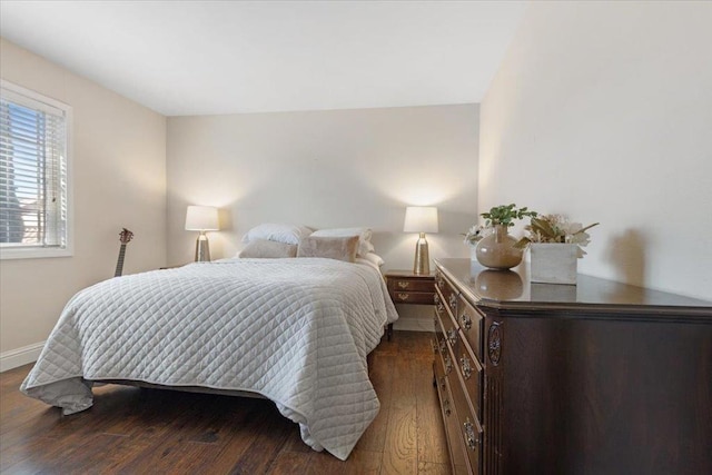 bedroom with dark hardwood / wood-style flooring