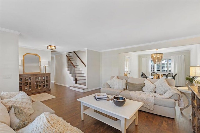 living room featuring crown molding, dark hardwood / wood-style floors, and an inviting chandelier