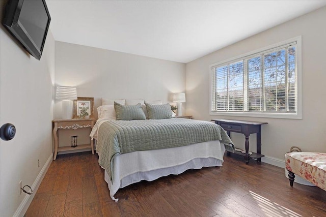 bedroom with dark hardwood / wood-style flooring