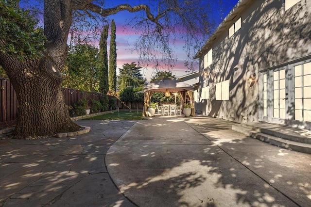 patio terrace at dusk with a gazebo and french doors