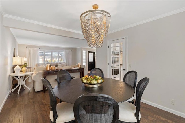 dining space with crown molding, dark wood-type flooring, and a notable chandelier