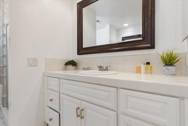 bathroom with vanity and decorative backsplash