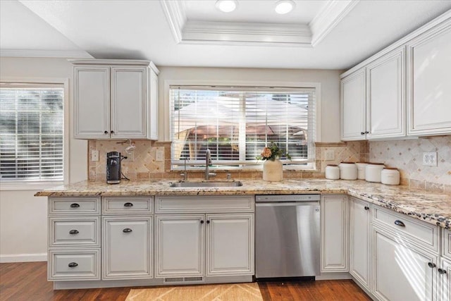 kitchen with sink, plenty of natural light, stainless steel dishwasher, and a raised ceiling