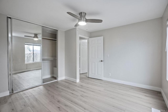 unfurnished bedroom featuring ceiling fan, a closet, and light hardwood / wood-style flooring