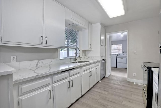 kitchen featuring sink, white cabinetry, separate washer and dryer, black range with electric cooktop, and light hardwood / wood-style floors