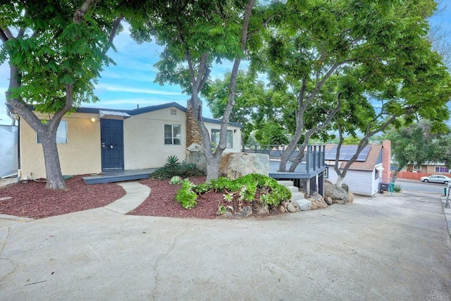 single story home featuring solar panels