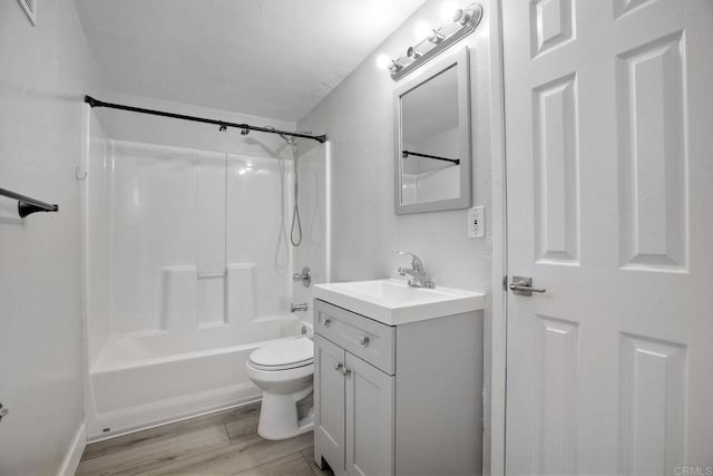 full bathroom with hardwood / wood-style flooring, vanity, toilet, and tub / shower combination