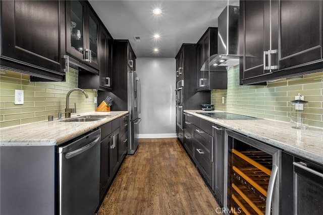 kitchen featuring dark wood-type flooring, sink, appliances with stainless steel finishes, beverage cooler, and wall chimney range hood