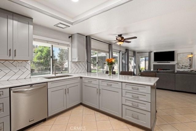 kitchen with gray cabinets, dishwasher, sink, and light tile patterned floors