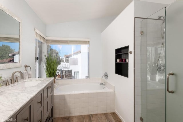 bathroom featuring vanity, shower with separate bathtub, and hardwood / wood-style floors