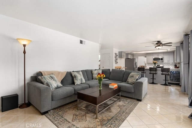 living room with ceiling fan and light tile patterned floors