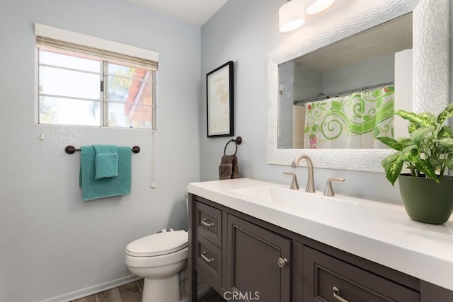 bathroom featuring vanity, hardwood / wood-style floors, and toilet