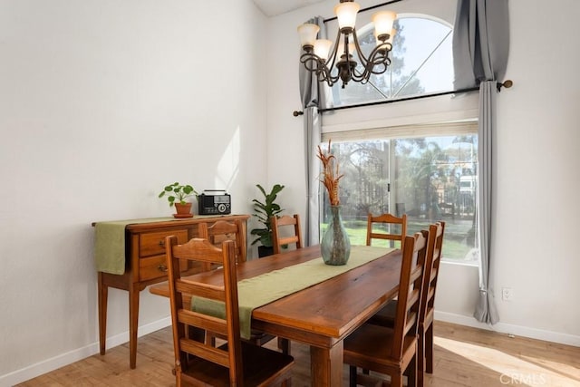 dining room with an inviting chandelier and light hardwood / wood-style floors