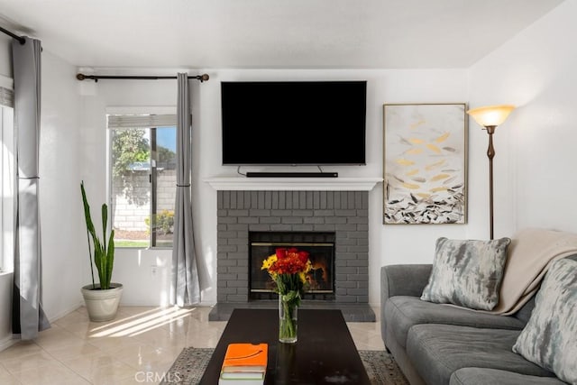 living room with a brick fireplace