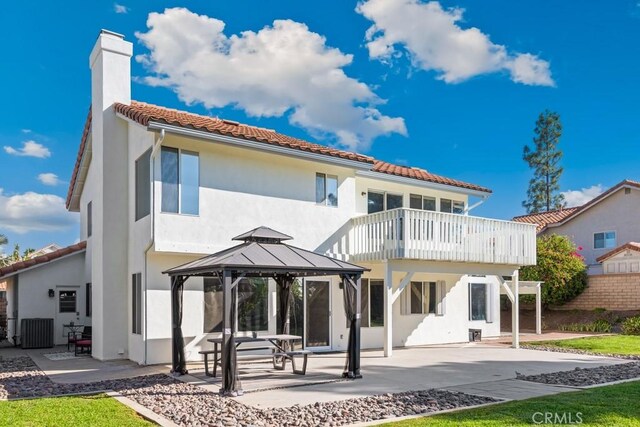 rear view of house with a gazebo, a balcony, central AC, and a patio