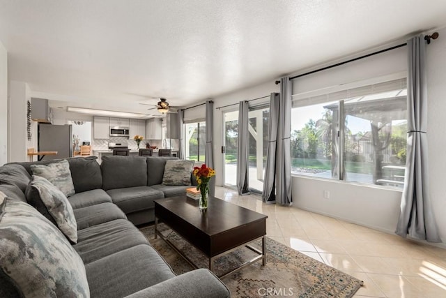 tiled living room featuring ceiling fan