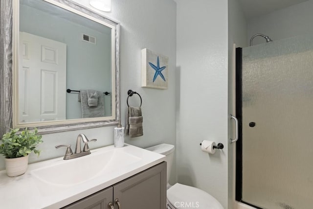 bathroom featuring walk in shower, vanity, and toilet