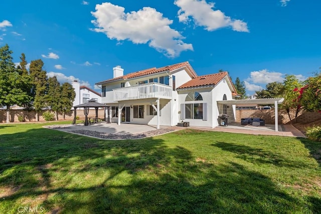 back of property featuring a gazebo, a yard, and a patio area