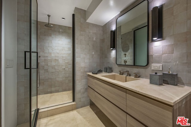 bathroom featuring tile walls, vanity, tasteful backsplash, and walk in shower