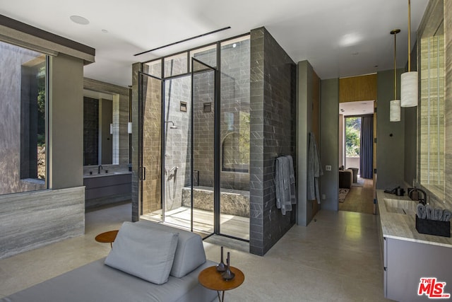 interior space featuring concrete flooring, vanity, and a tub