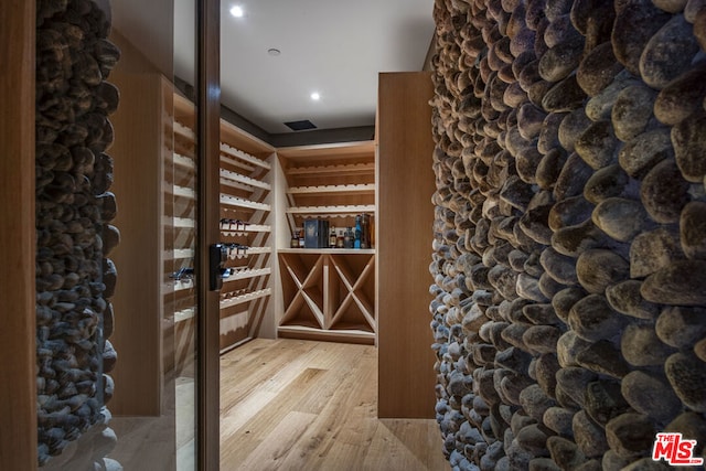 wine room with hardwood / wood-style floors