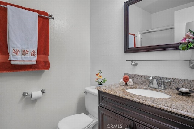 bathroom featuring vanity and toilet