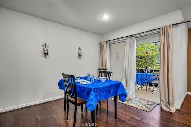 dining space with dark hardwood / wood-style flooring