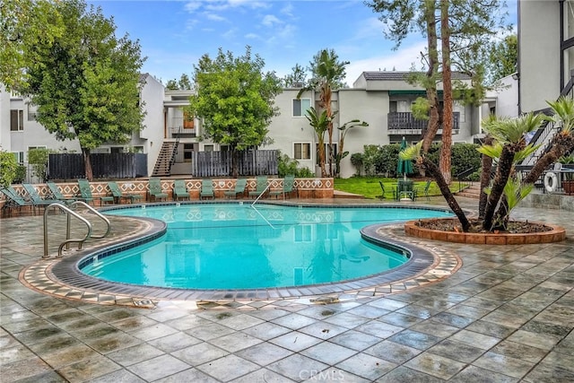 view of swimming pool featuring a patio area