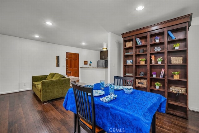 dining area featuring dark wood-type flooring