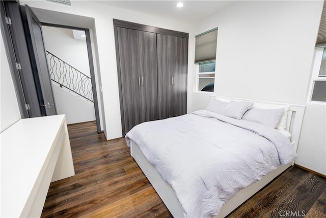 bedroom featuring dark wood-type flooring and recessed lighting