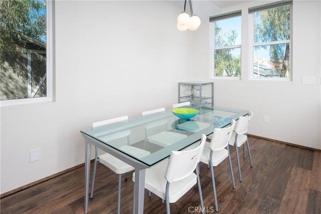 dining room with dark wood-style flooring and baseboards