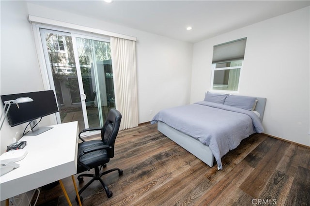 bedroom with dark wood-style floors and recessed lighting