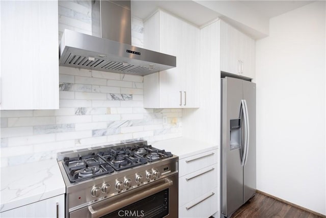 kitchen with stainless steel appliances, light stone countertops, wall chimney exhaust hood, tasteful backsplash, and modern cabinets