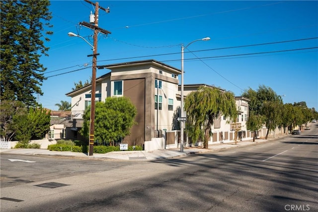 view of road featuring curbs, sidewalks, and street lights