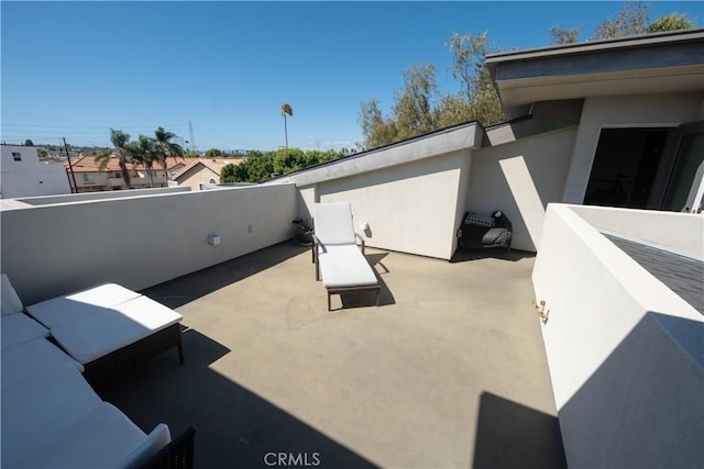 view of patio featuring a balcony