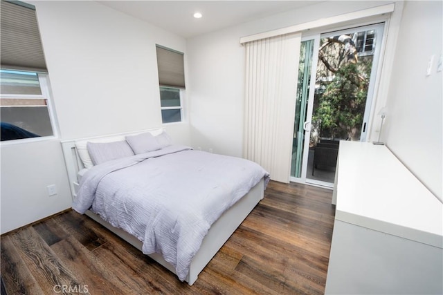 bedroom with dark wood-type flooring, recessed lighting, and access to outside