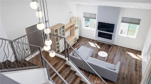 interior space with recessed lighting, dark wood-style flooring, a fireplace, and stairs