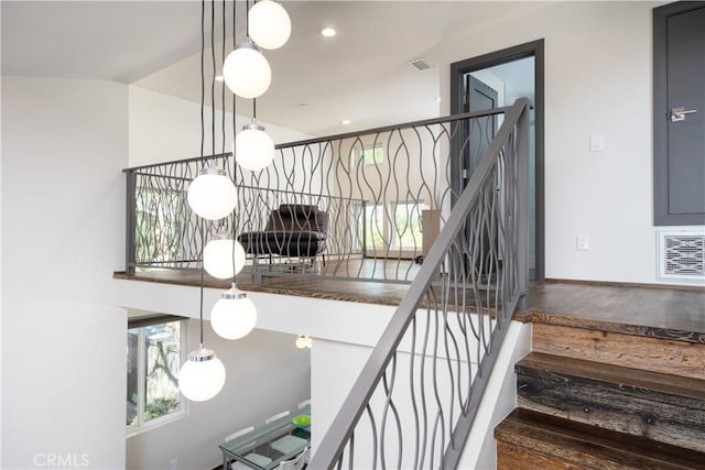 staircase featuring recessed lighting, visible vents, and wood finished floors