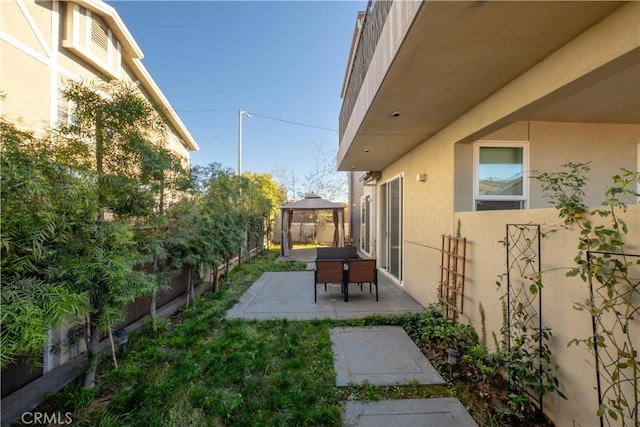 view of yard featuring a fenced backyard, a patio, and a gazebo