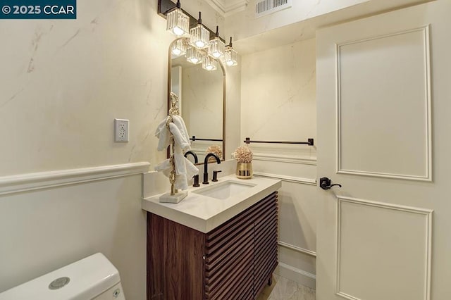 bathroom featuring vanity and toilet