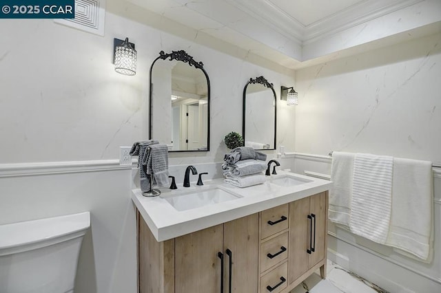 bathroom featuring vanity, crown molding, and toilet